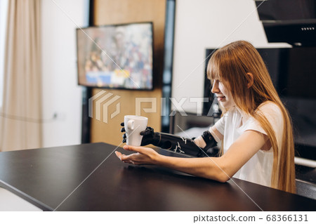 new discovery, cheerful girl holding a cup without efforts 68366131