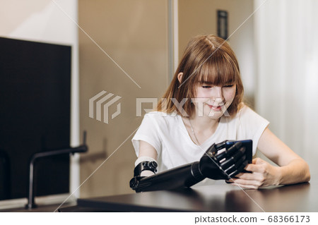 happy girl is holding a gadget and using it without difficulties happy girl is holding a gadget and using it without difficulties 68366173