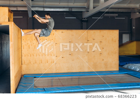young active man doing stunts with wall 68366223