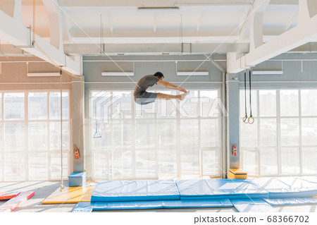 flexible gymnast is doing some exercises on the air 68366702