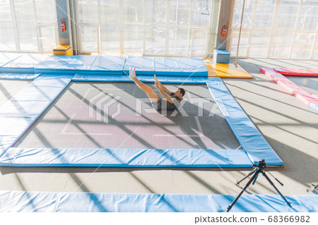 man trying to stand up after jumping 68366982