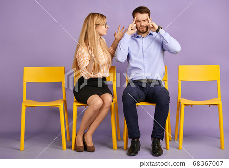 young man and young blonde woman conflicting 68367007