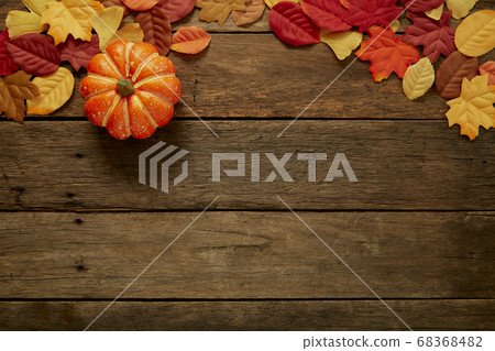 Autumn background with leaves and pumpkins on dark 68368482