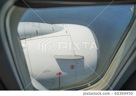 Jet engine seen from an airplane window 68369450