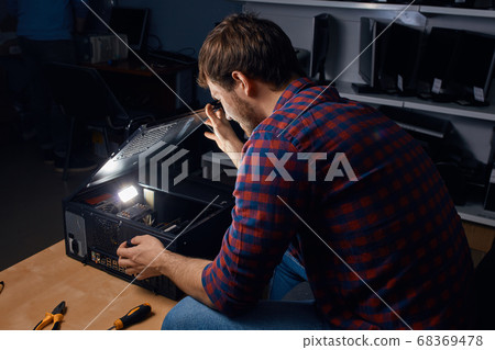 awesome happy man enjoying working with broken computers awesome happy man enjoying working with broken computers 68369478