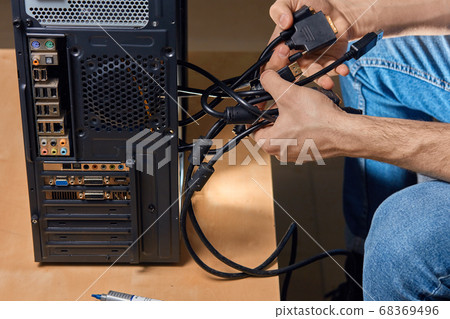 man holding fixed wires, guy trying to untangle the wires man holding fixed wires, guy trying to untangle the wires 68369496