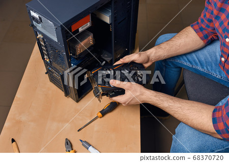man is maintaining computer equipment man is maintaining computer equipment 68370720