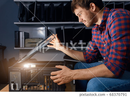 guy working on a small computer repair company guy working on a small computer repair company 68370791