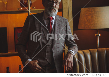 Toned retro styled portrait of businessman sitting in armchair at office Toned retro styled portrait of businessman sitting in armchair at office 68373168