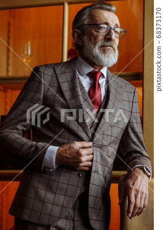 Toned retro styled portrait of businessman sitting in armchair at office Toned retro styled portrait of businessman sitting in armchair at office 68373170