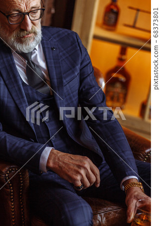 Toned retro styled portrait of businessman sitting in armchair at office Toned retro styled portrait of businessman sitting in armchair at office 68373801