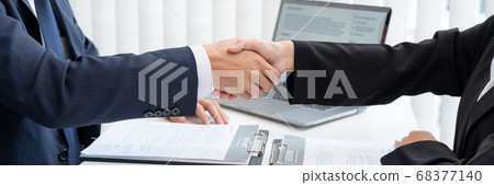 two business people shaking hands of Candidate 68377140