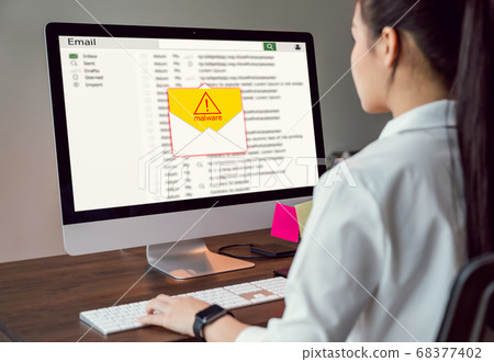Concept of cyber crime, businesswoman using computer and show malware screen that comes 68377402