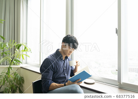 A man reading a book A man reading a book 68377516