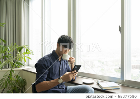A smartphone and a man A smartphone and a man 68377580