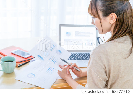 A woman looking over the created material A woman looking over the created material 68377710