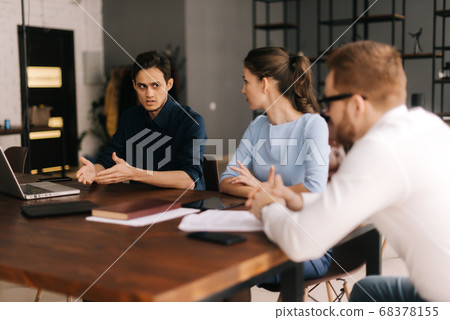 Young business man tells his colleagues about the project. Young business man tells his colleagues about the project. 68378155