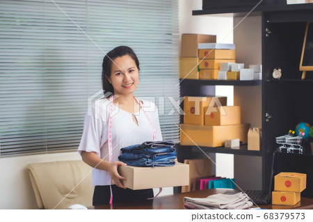 Asian female seller prepare parcel box of product Asian female seller prepare parcel box of product 68379573