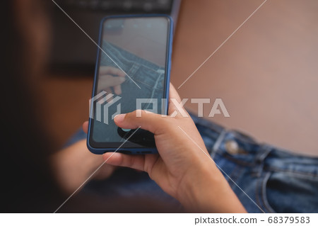 Clothing business owner is taking photos of their 68379583