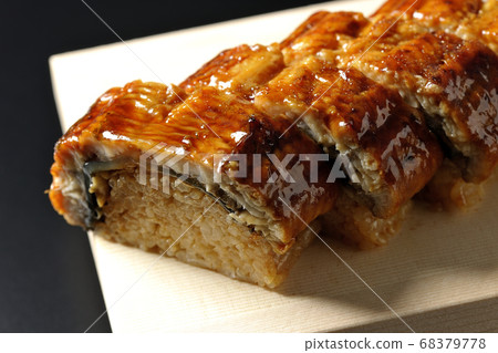 Shooting eel sushi served on sushi clogs on a black background Shooting eel sushi served on sushi clogs on a black background 68379778