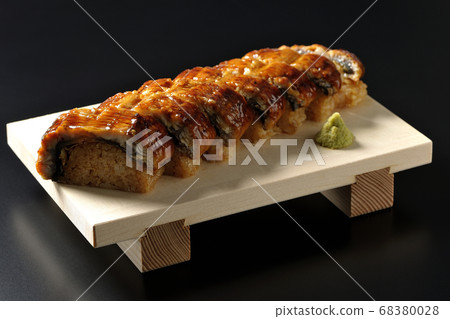Unagi sushi and wasabi served on sushi geta (black background) 68380028