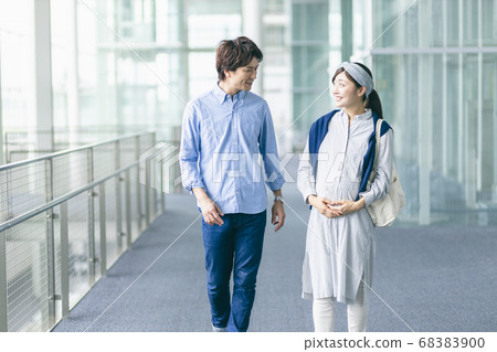 Pregnant woman walking 68383900