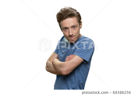 Portrait of angry offended teen boy with his arms crossed. 68386256