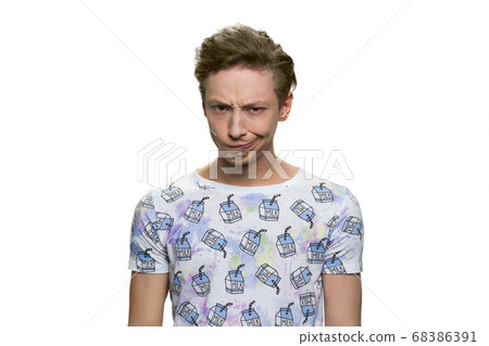Teen boy is scowling. 68386391
