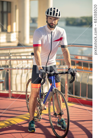 Serious man in sportswear and helmet on bicycle 68388020