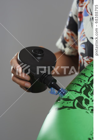 man inflating a pool air mattress man inflating a pool air mattress 68388705