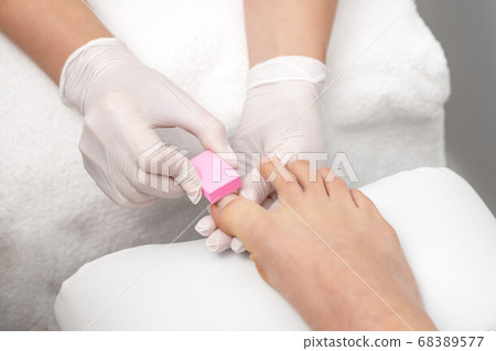 Close up of woman receiving pedicure Close up of woman receiving pedicure 68389577