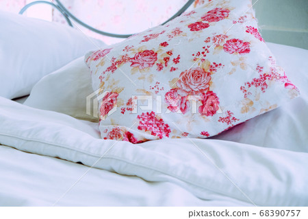 Bright bedroom interior with flower pattern pillows on bed Bright bedroom interior with flower pattern pillows on bed 68390757