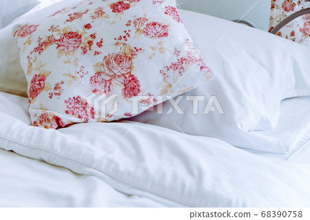 Bright bedroom interior with flower pattern pillows on bed Bright bedroom interior with flower pattern pillows on bed 68390758
