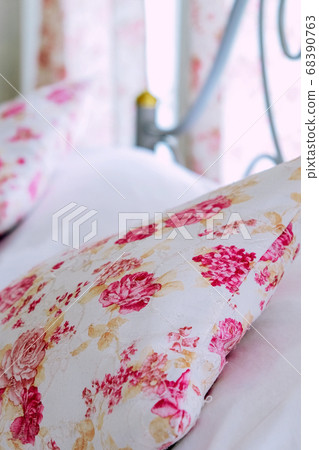 Bright bedroom interior with flower pattern pillows on bed Bright bedroom interior with flower pattern pillows on bed 68390763