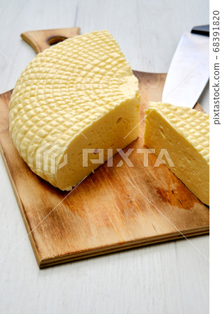 Soft cheese on wooden cutting board 68391820