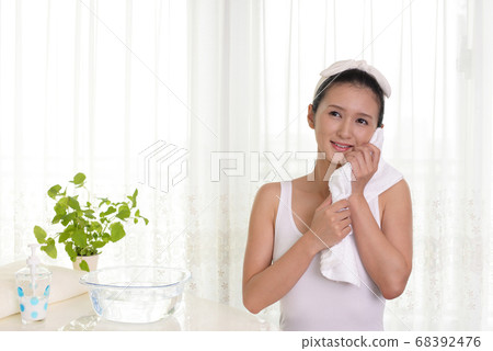 A woman relaxing with a smile A woman relaxing with a smile 68392476