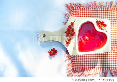 Red and ripe red currants and heart shaped bowof Red and ripe red currants and heart shaped bowof 68395495