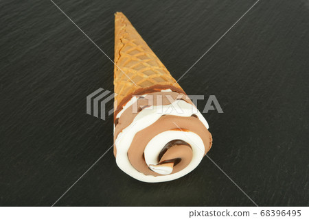 Waffle cone with ice cream on a black background. Waffle cone with ice cream on a black background. 68396495