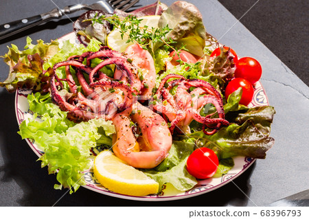 Octopus on blue plate with salad and lemon Octopus on blue plate with salad and lemon 68396793
