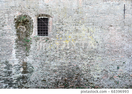 Ancient brick wall and window locked with metal bars Ancient brick wall and window locked with metal bars 68396993
