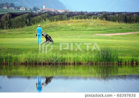 Golfer with golf cart watching a partner. Golfer with golf cart watching a partner. 68397638
