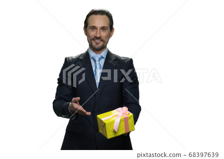 Cheerful boss holding a present in yellow box. Cheerful boss holding a present in yellow box. 68397639