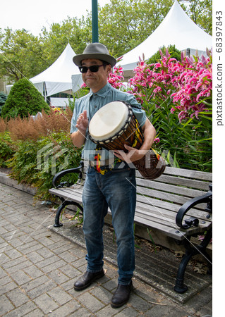 Asian man standing and holding djembe aside Vancouver Vancouver British Columbia Canada Asian man standing and holding djembe aside Vancouver Vancouver British Columbia Canada 68397843