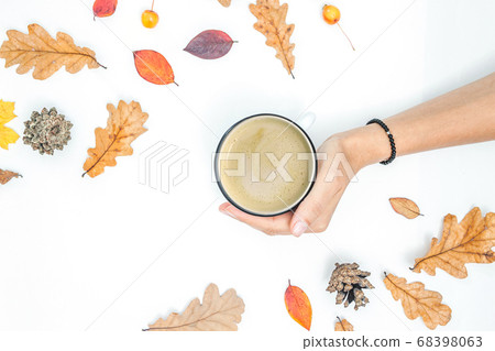 Cup of coffee, women scarf, autumn leaves on white Cup of coffee, women scarf, autumn leaves on white 68398063