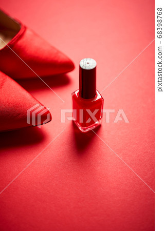 red high heel shoes and nail polish on a minimalist background red high heel shoes and nail polish on a minimalist background 68398768
