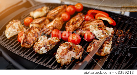 juicy roasted meat, tomatoes, red pepper on the grill on the street juicy roasted meat, tomatoes, red pepper on the grill on the street 68399218