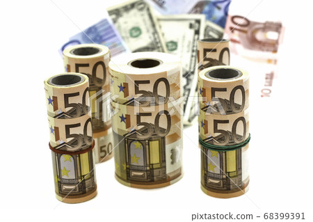 currency of different denominations in rolls and in bulk on a white background 68399391