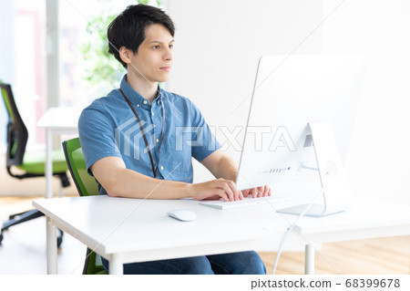 Man working at a desk photo material Man working at a desk photo material 68399678