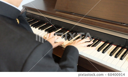 Hands of high school boys practicing piano wearing school run Hands of high school boys practicing piano wearing school run 68400914