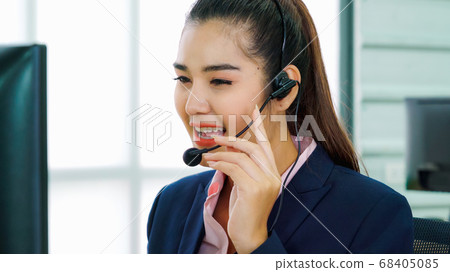 Business people wearing headset working in office Business people wearing headset working in office 68405085